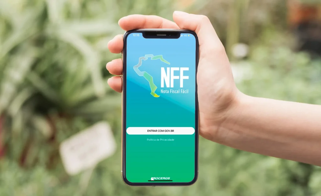 A imagem mostra uma mão segurando o celular e na tela do celular a imagem do aplicativo da Nota Fiscal Fácil