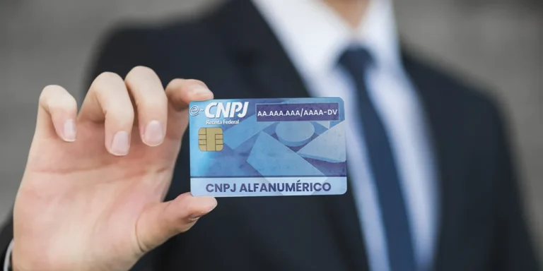 Pessoa de terno segurando cartão do cnpj com o novo modelo do cnpj alfanumérico